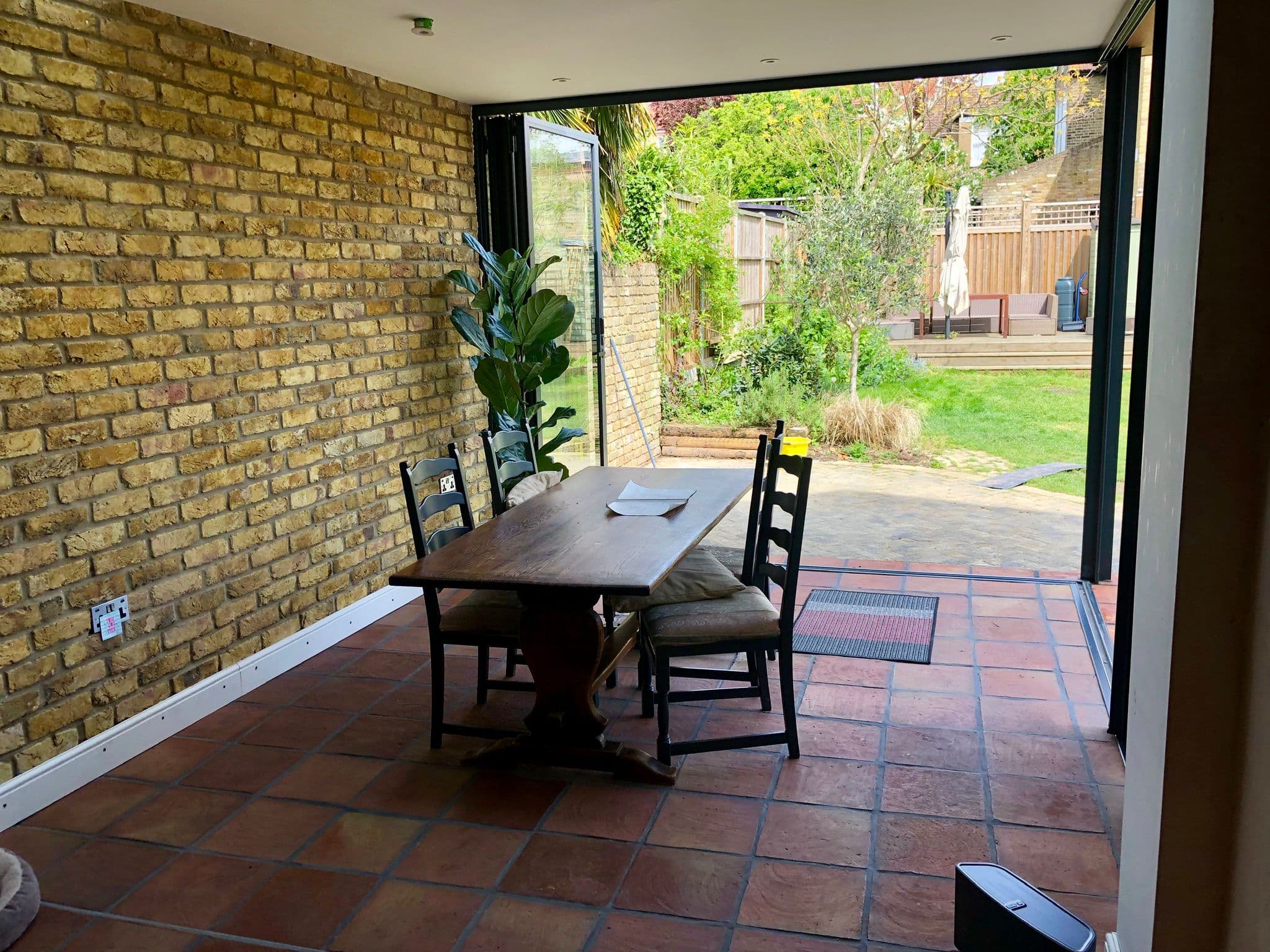 Garden-room dining space with terracotta floor