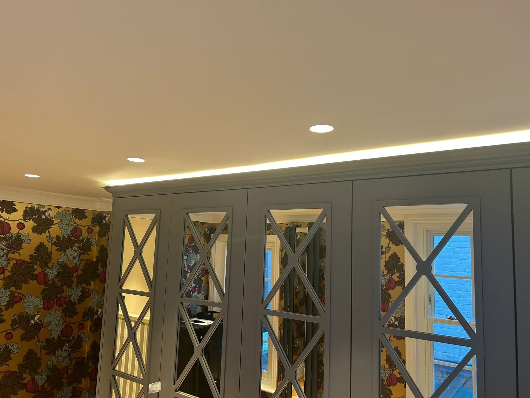 Fitted mirrored wardrobes with concealed lighting