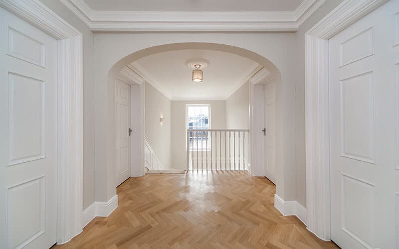 Arched hallway with herringbone parquet flooring