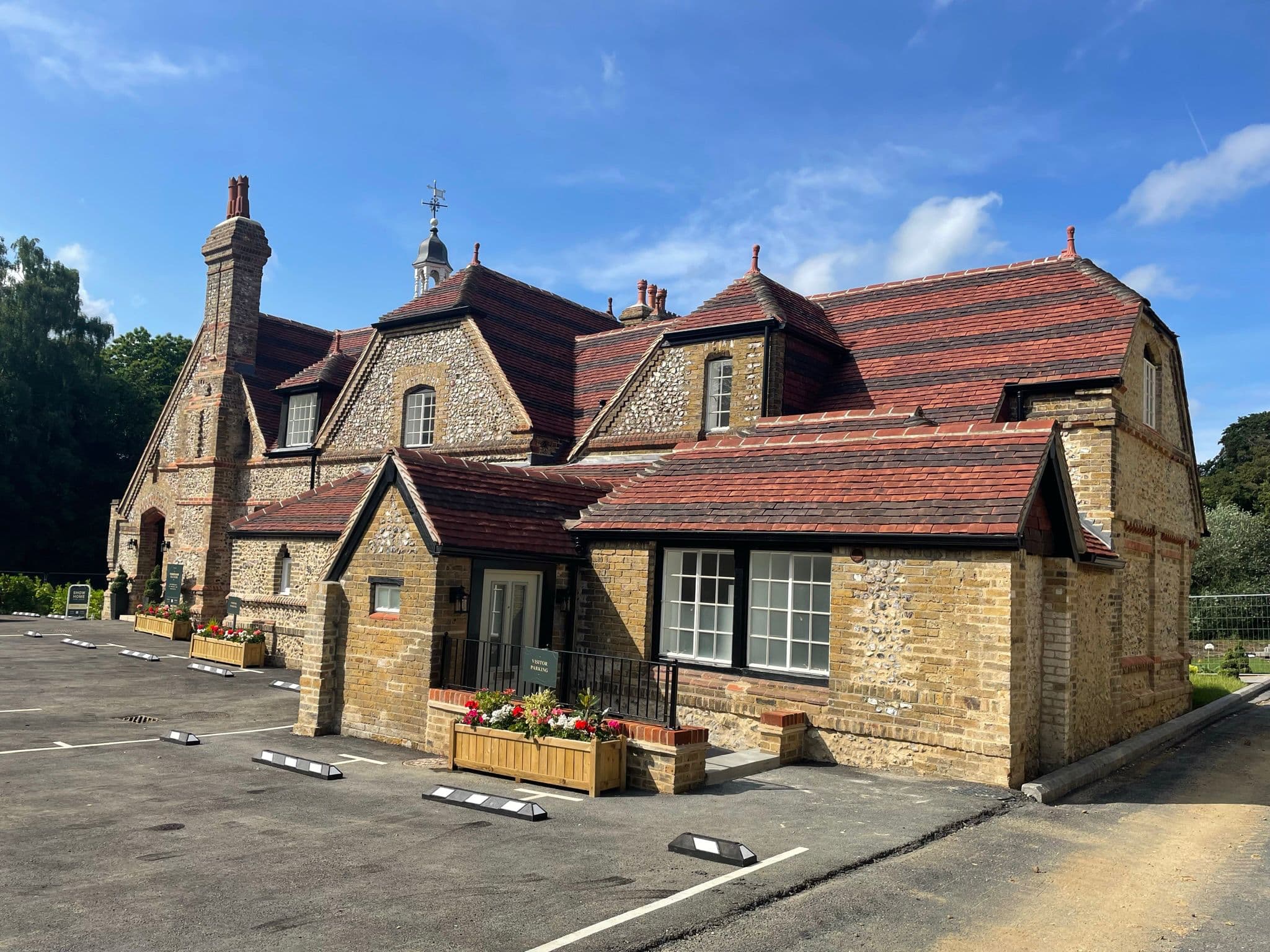Restored stone outbuilding with clay tile roofs